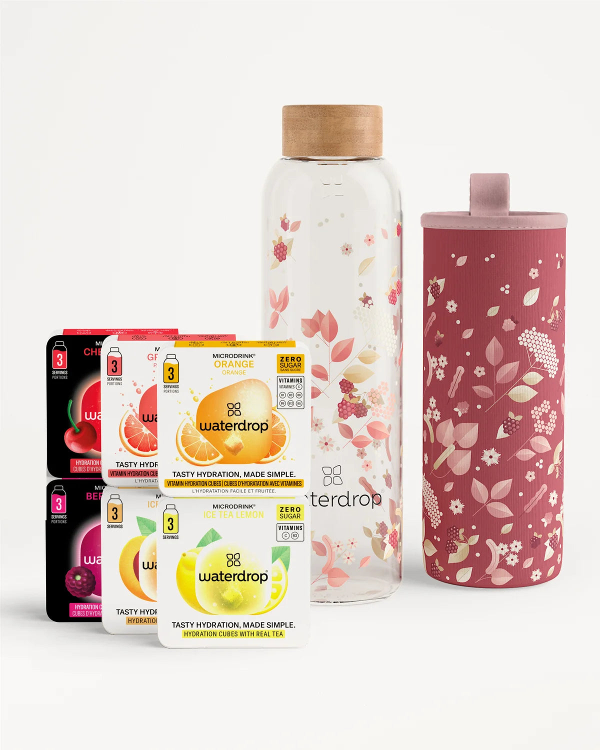 Ensemble de sachets de boissons Waterdrop avec une bouteille en verre à bouchon en bois et une housse isotherme rose à motifs floraux.